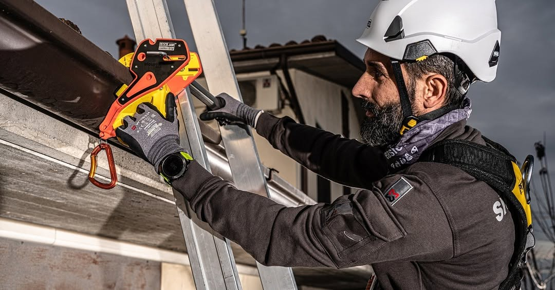 Worker securing ladder to gutter using Lock Jaw Ladder Grip for safety