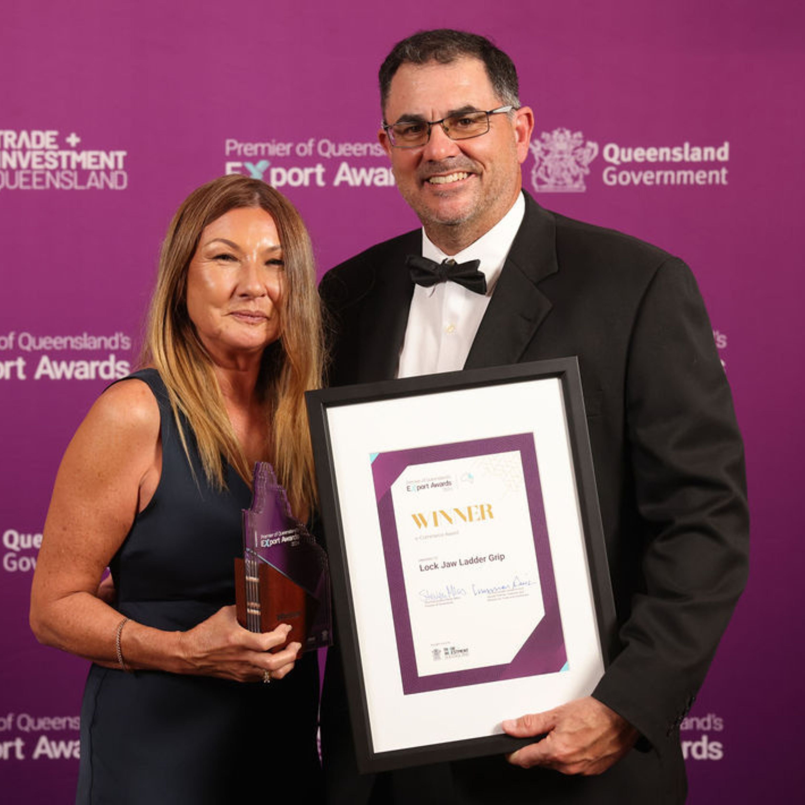 Gail && Craig holding a trophy and framed award certificate at the Queensland Export Awards.