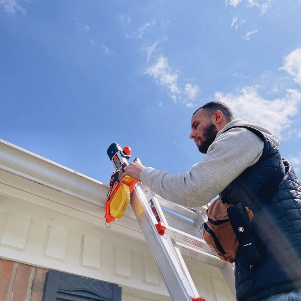 A man setting up the ladder fall protection from lock jaw ladder grip