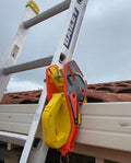 A gutter clamp securing the ladder at the eave