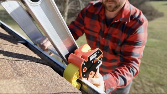 A portable clamp securing the ladder at the gutter