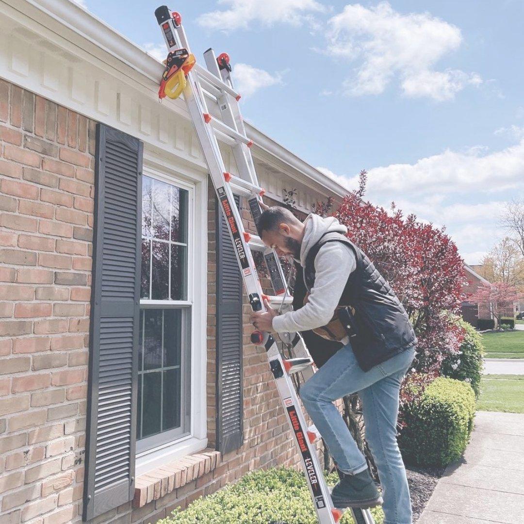 Ladder secured at the gutter, with three points of contact on the way up