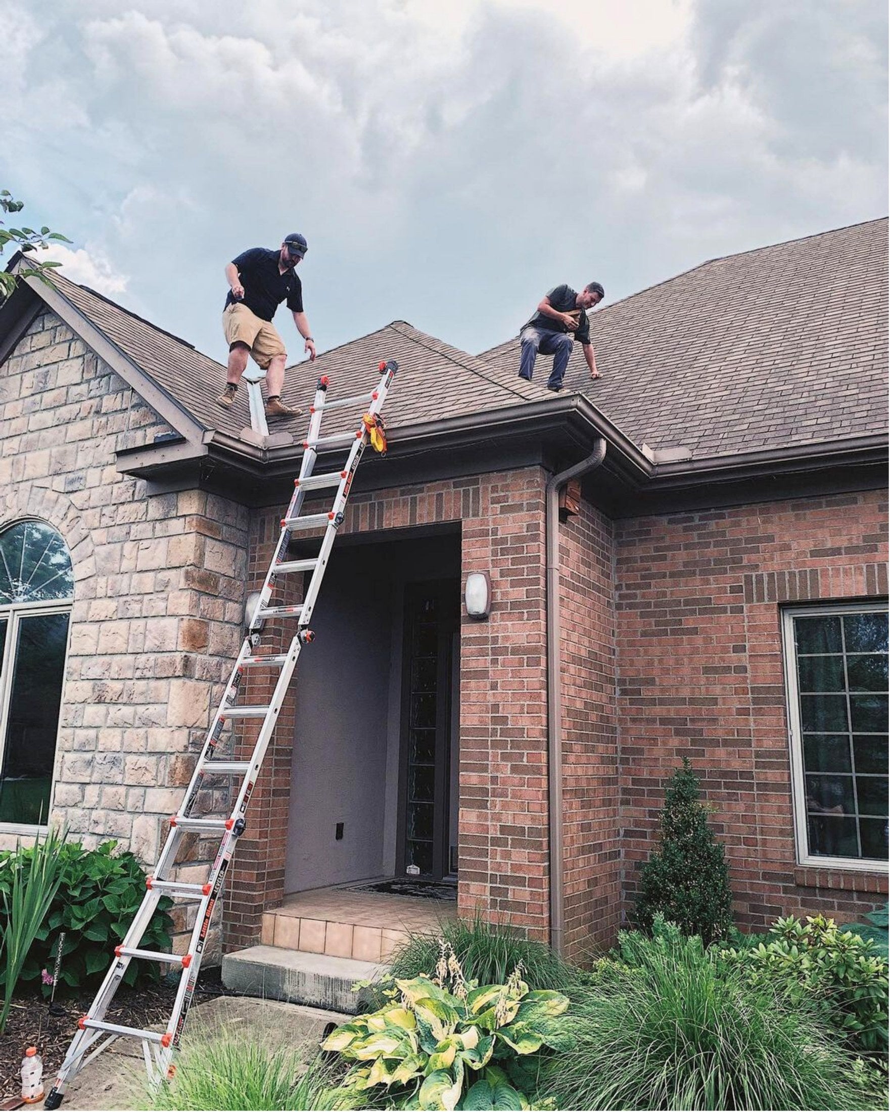Extension ladder secured to a residential gutter with two Lock Jaw Ladder Grips