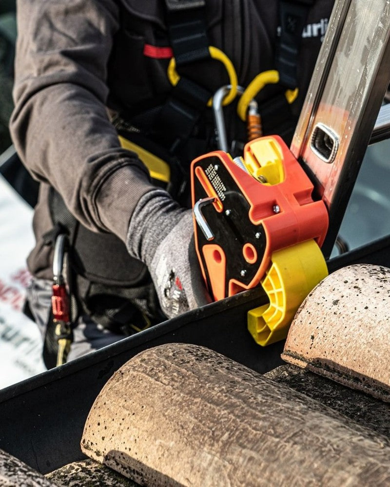 Lock Jaw Ladder Grip carried beside an extension ladder