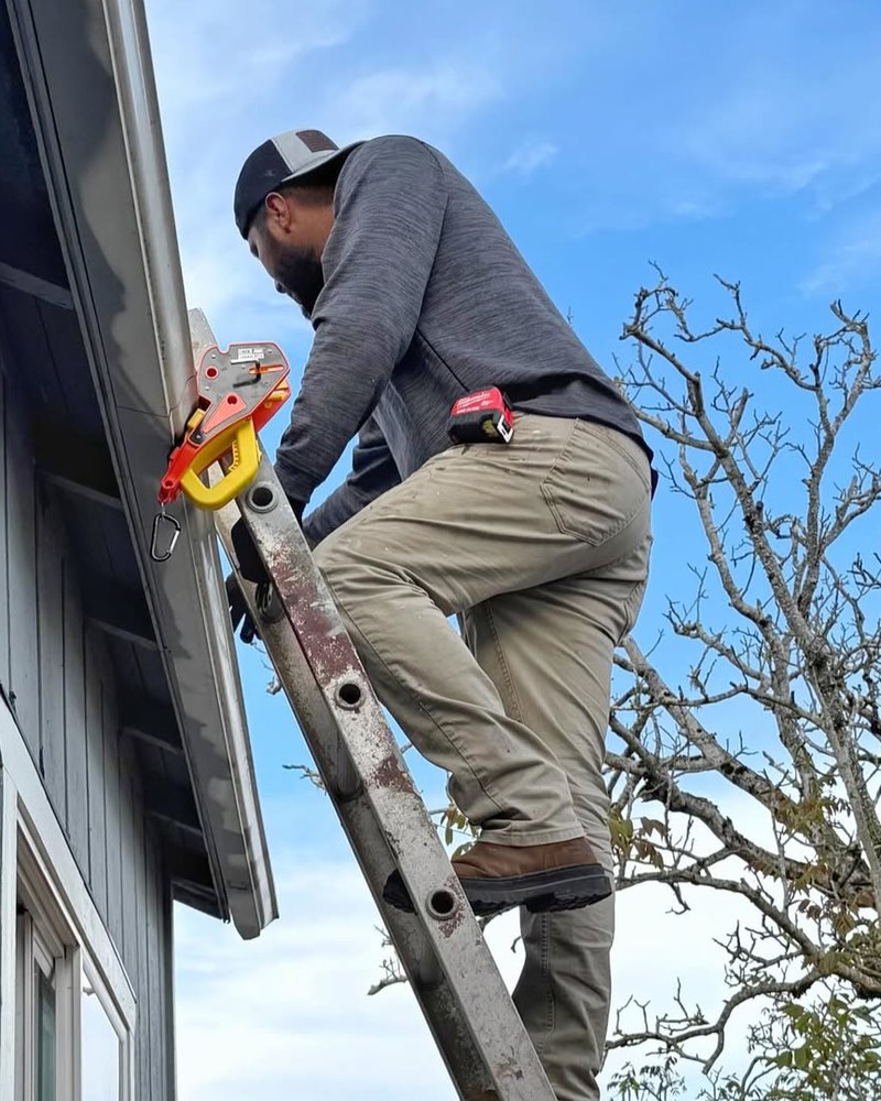 An inspector using a Lock Jaw Ladder Grip on an extension ladder