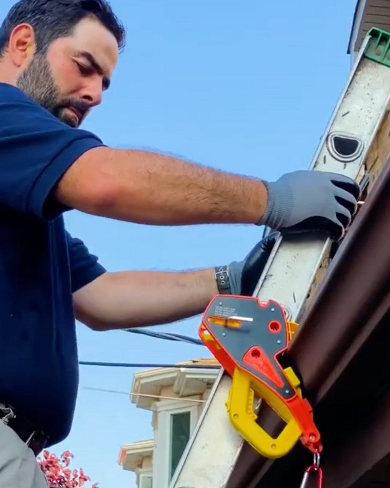 A Lock Jaw Ladder Grip securing an extension ladder at a gutter