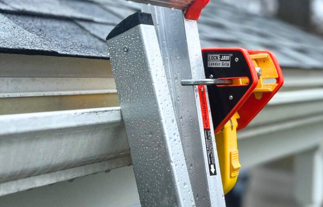 Extension ladder locked to a house gutter with a Lock Jaw Ladder Grip